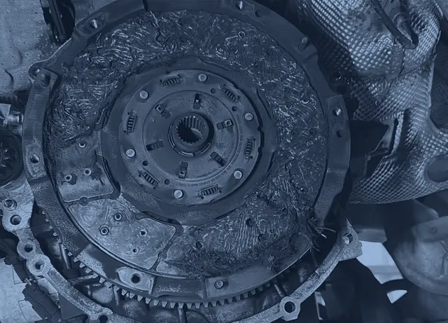 A worn clutch on the flywheel with the gearbox removed, during a clutch replacement in our workshop